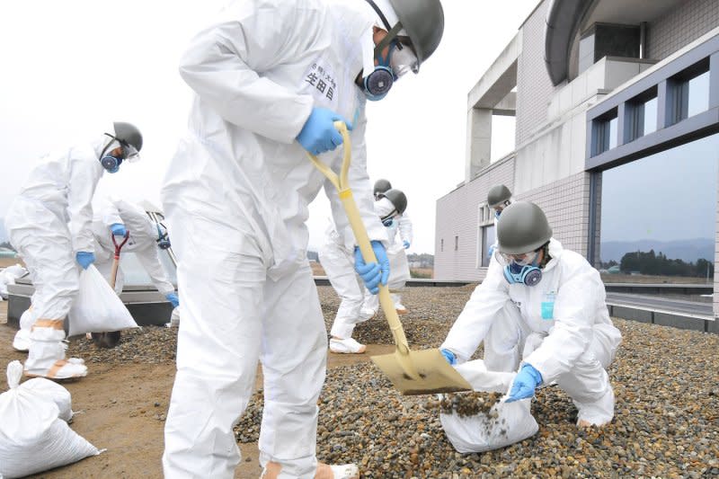 Member of Japan's Ground Self Defense Force decontaminate at the city office of Tomioka Machi, five miles from the Fukushima Dai-ichi nuclear power plant in Japan on Dec. 8, 2011. File Photo by Keizo Mori/UPI