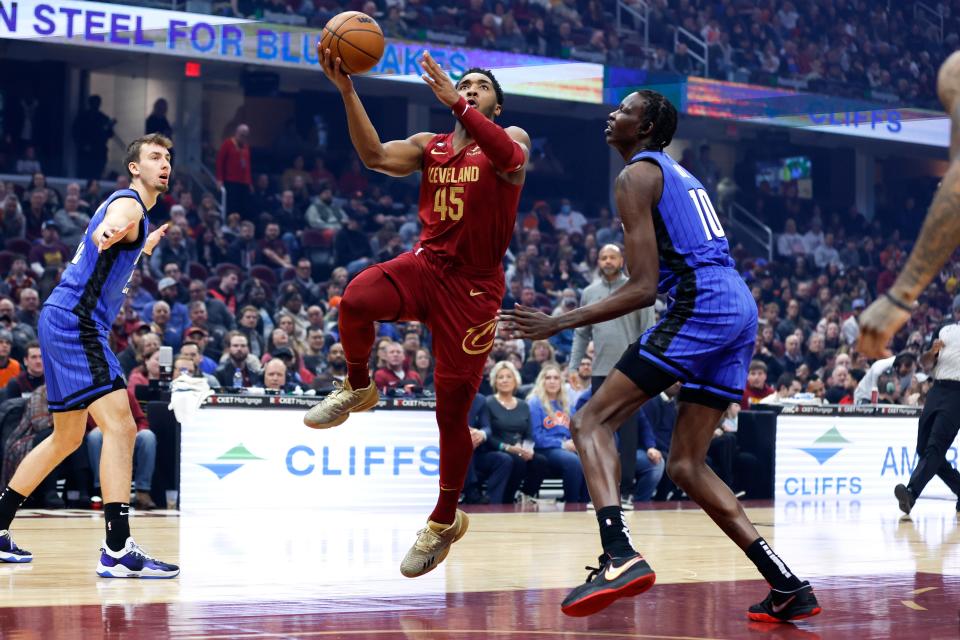 Cleveland Cavaliers guard Donovan Mitchell (45) shoots against Orlando Magic center Bol Bol (10) during the first half of an NBA basketball game, Friday, Dec. 2, 2022, in Cleveland. (AP Photo/Ron Schwane)