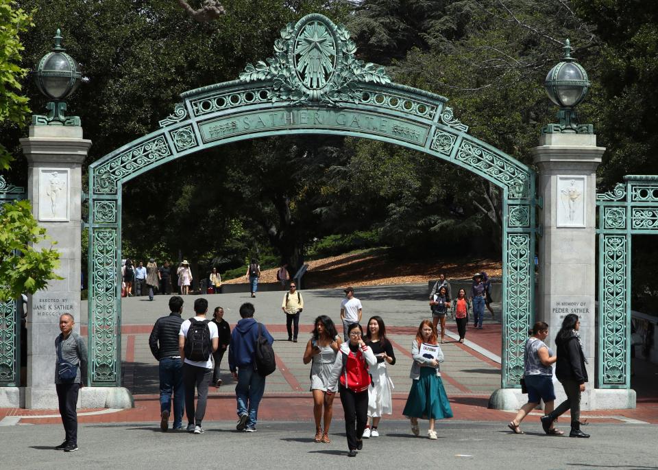 Students walk past Sather Gate on the University of California at Berkeley campus in Berkeley, Calif.