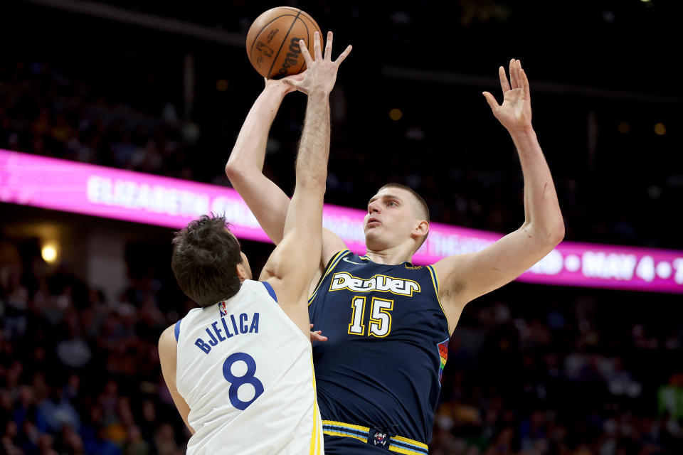 DENVER, COLORADO - APRIL 24: Nikola Jokic #15 of the Denver Nuggets puts yp a shot over Nemanja Bjelica #8 of the Golden State Warriors in the first quarter during Game Four of the Western Conference First Round NBA Playoffs at Ball Arena on April 24, 2022 in Denver, Colorado. NOTE TO USER: User expressly acknowledges and agrees that, by downloading and/or using this photograph, User is consenting to the terms and conditions of the Getty Images License Agreement. (Photo by Matthew Stockman/Getty Images)
