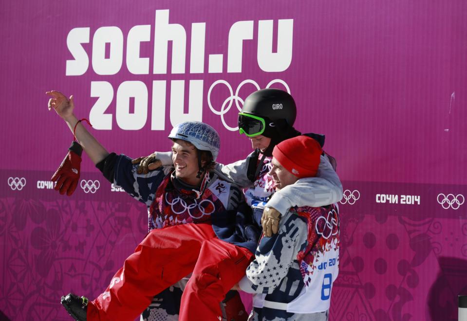 Gold medal winner Joss Christensen of the United States, top, is carried by compatriots Nicholas Goepper, left, who won bronze, and Gus Kenworthy, who won silver, after the men's ski slopestyle final at the Rosa Khutor Extreme Park, at the 2014 Winter Olympics, Thursday, Feb. 13, 2014, in Krasnaya Polyana, Russia. (AP Photo/Gero Breloer)