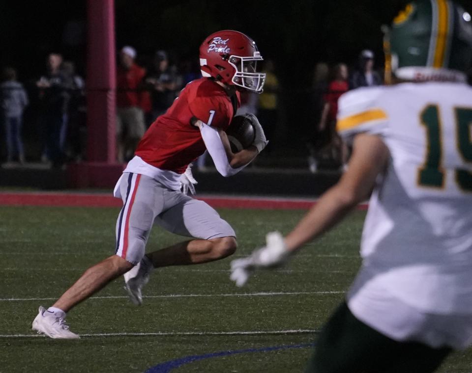 Quakers Caden Vanderbush (1) runs the ball during the game between the Plainfield Quakers and the Greenwood Woodmen on Friday, Sept. 15, 2023, at Plainfield High School in Plainfield. The Quakers beat the Woodmen 46-20.