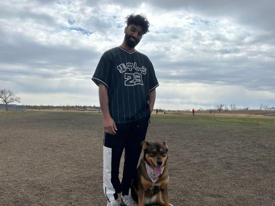 Harpreet Singh and his dog Brownie at a Regina dog park. He says he's very worried about the tick season, and plans on getting his four-year-old dog protective medication. 