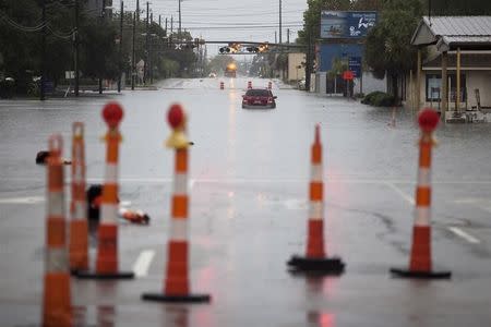 A car is stalled due to heavy rains, along flooded US 17 in Georgetown, South Carolina October 4, 2015. REUTERS/Randall Hill