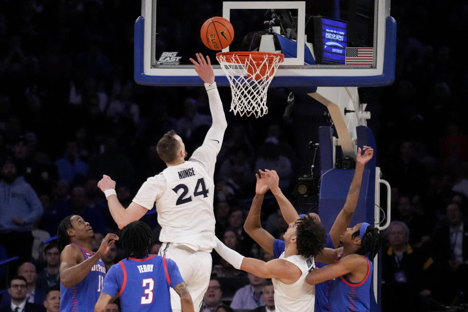 Xavier's Jack Nunge (24) scores the go-ahead two point shot against DePaul's Eral Penn (11) in the second half of an NCAA college basketball game during the quarterfinals of the Big East conference tournament, Thursday, March 9, 2023, in New York. (AP Photo/John Minchillo)