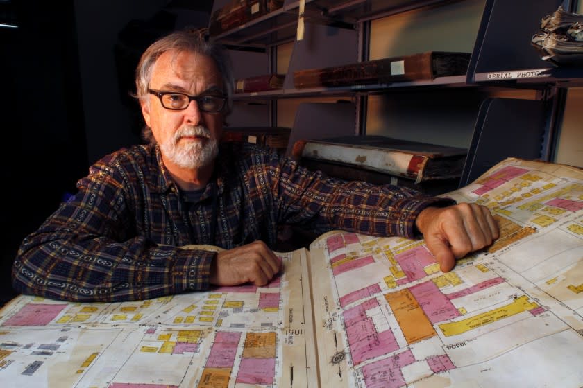 LOS ANGELES CA SEPTEMBER 13, 2012: Los Angeles Public Library history librarian Glen Creason, an expert on maps, shows a 1935 volume 10 Sanborn map. The hefty atlases produced by D.A. Sanborn from the 1880s to 1970 show changes from block to block like no other cartographic resource and open up our knowledge of what our cities looked like before this modern age. At the Los Angeles Public Library, Los Angeles on Sept 13, 2012. (Glenn Koenig/Los Angeles Times)