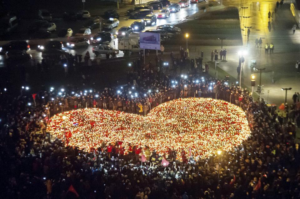 <p>People stand by a heart shaped with candles as a tribute to slain President of Gdansk Pawel Adamowicz in Gdansk, Poland, Wednesday, Jan. 16, 2019. (AP Photo/Wojciech Strozyk) </p>