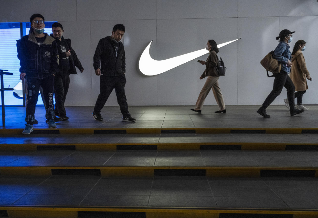 BEIJING, CHINA - APRIL 08: People walk outside a Nike store at a shopping area on April 8, 2021 in Beijing, China. (Photo by Kevin Frayer/Getty Images)