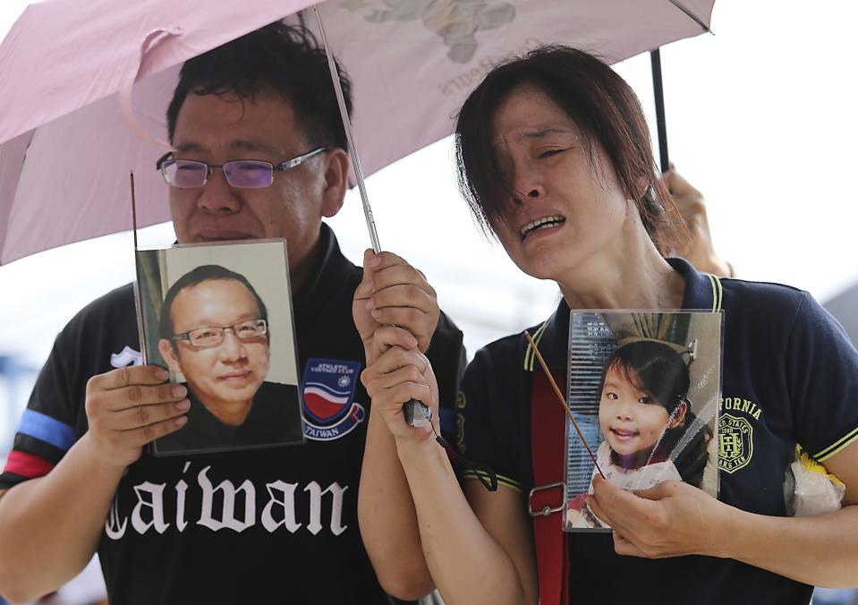 Relatives of passengers onboard the TransAsia Airways plane that crashed cry at a funeral parlor on Taiwan's offshore island of Penghu, July 24, 2014. Taiwan authorities launched an investigation on Thursday into the crash of a TransAsia Airways turboprop plane in which 48 people were killed with the weather expected to be a factor in the inquiry. (REUTERS/Edward Lau)