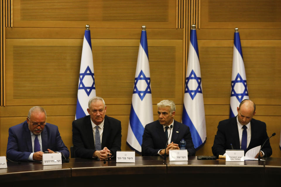 FILE - In this Sunday, June 13, 2021, file photo, Avigdor Lieberman, from left, Benny Gantz, Yair Lapid and Israel's new prime minister Naftali Bennett hold a first cabinet meeting in Jerusalem. Israel's parliament is set to vote Monday, July 5, 2021, on whether to renew a temporary law first enacted in 2003 that bars Arab citizens of Israel from extending citizenship or even residency to spouses from the occupied West Bank and Gaza. (AP Photo/Ariel Schalit, File)