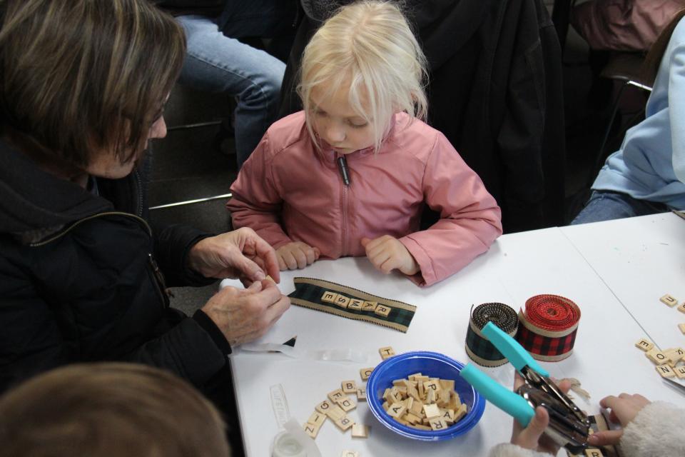 Families work on crafts at the Van Meter Public Library on Saturday, Dec. 3, 2022.