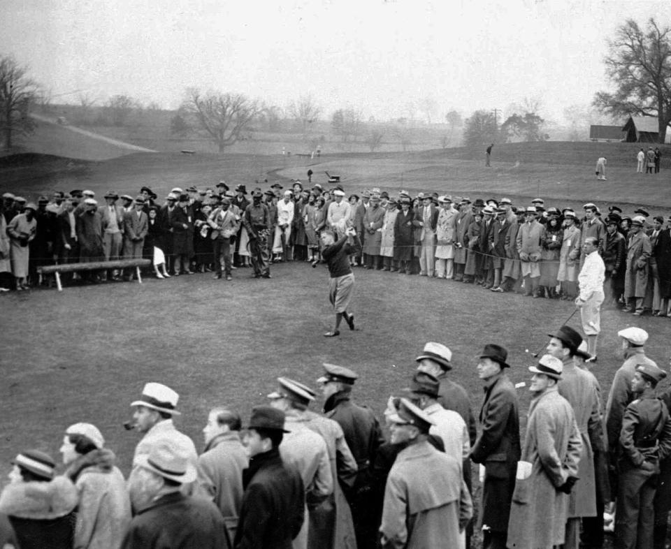 Bobby Jones (center) unleashes a drive during the 1934 Masters Tournament. One of the last surviving tickets to that tournament is expected to be sold at auction Dec. 6.