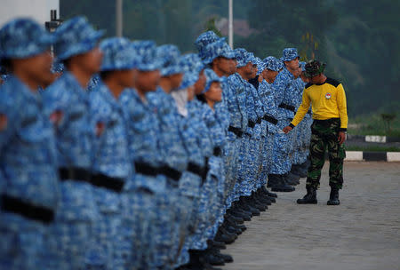 A military trainer inspects participants of the Bela Negara - "defend the nation" - program as they stand at attention at a training center in Rumpin, Bogor, West Java, Indonesia. REUTERS/Darren Whiteside