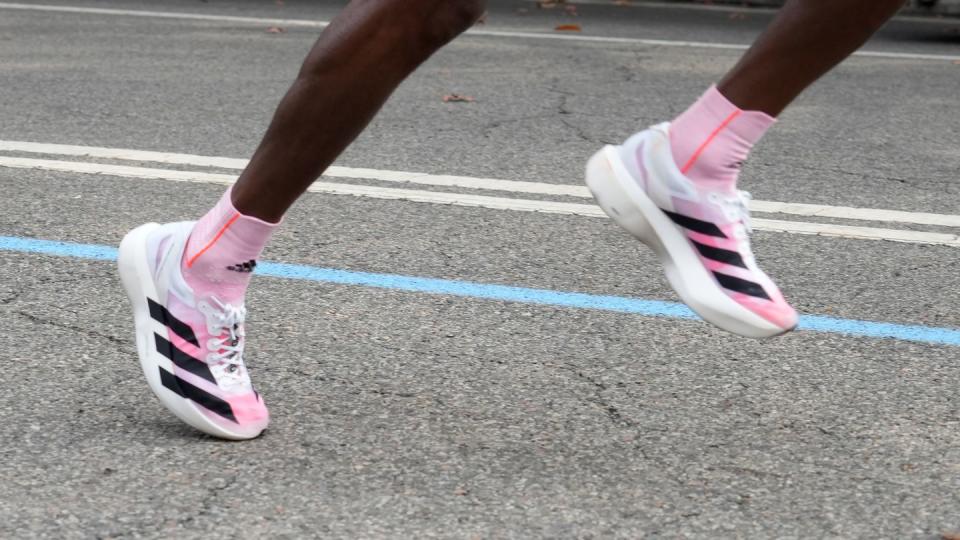 tamirat tola wearing adidas running shoes