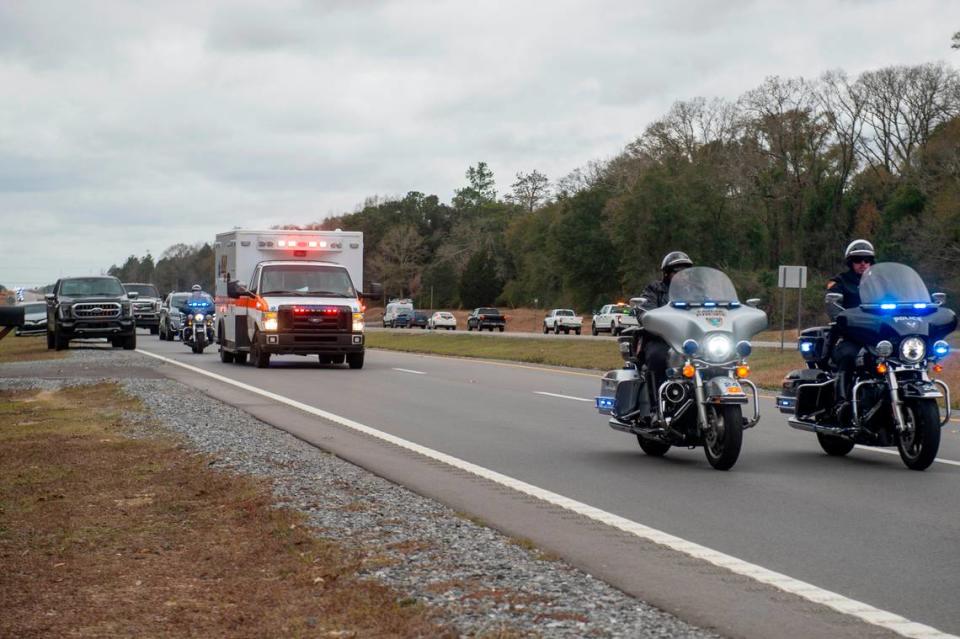 A procession escorting George County Sheriff’s officer Jeremy Malone, who was killed on Thursday, arrives at Moments Funeral Home in Lucedale on Friday, Jan. 5, 2024.