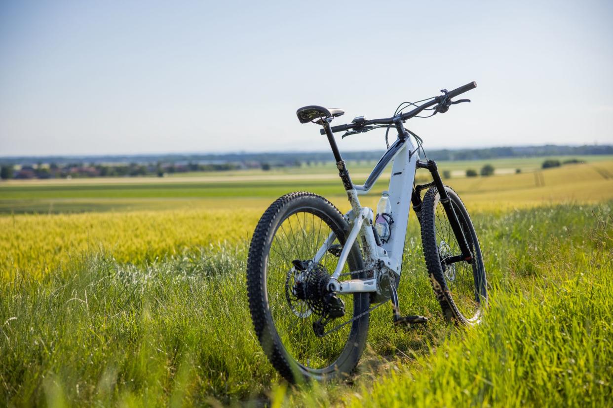 Electric bicycle parked on agricultural field on a sunny day