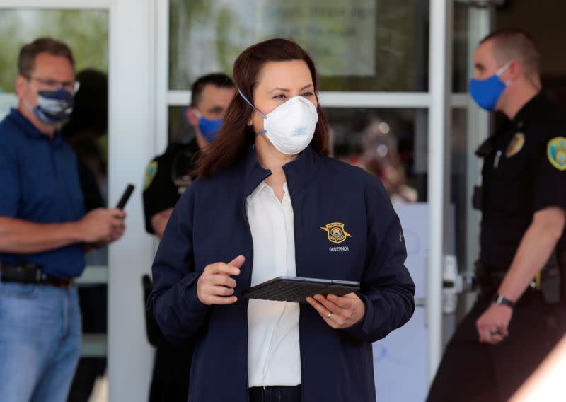 FILE PHOTO: Michigan Governor Gretchen Whitmer wears a face mask as she arrives to address the media about the flooding along the Tittabawassee River, after several dams breached, in downtown Midland