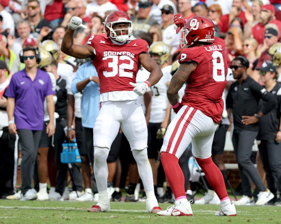Oklahoma's R Mason Thomas (32) and Jonah Laulu (8) celebrate a play in the second half of the college football game between the University of Oklahoma Sooners and the University of Central Florida Knights at Gaylord Family Oklahoma-Memorial Stadium in Norman, Okla., Saturday, Oct., 21, 2023.