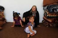 A mother and her children, Afghan refugees, are pictured on September 22, 2013 at an UNHCR centre in Herat after being deported from Iran