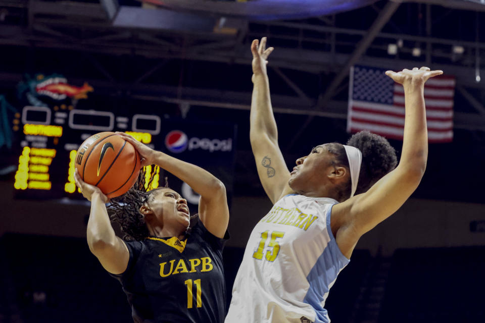 Arkansas-Pine Bluff guard Tia Morgan (11) shoots as Southern forward Sky Castro (15) defends during the second half of an NCAA college basketball game in the championship of the Southwestern Athletic Conference Tournament, Saturday, March 11, 2023, in Birmingham, Ala. (AP Photo/Butch Dill)