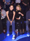  The BFFs interpreted courtside style much differently. Karlie Kloss went for a classier version of what the people wear — jeans, Converse, and a black turtleneck tank top — while Taylor Swift went full on glamour puss. Rocking head-to-toe black, the singer’s cheetah print high heels with socks stand out as unsuitable in a sea of flat sensible shoes. 