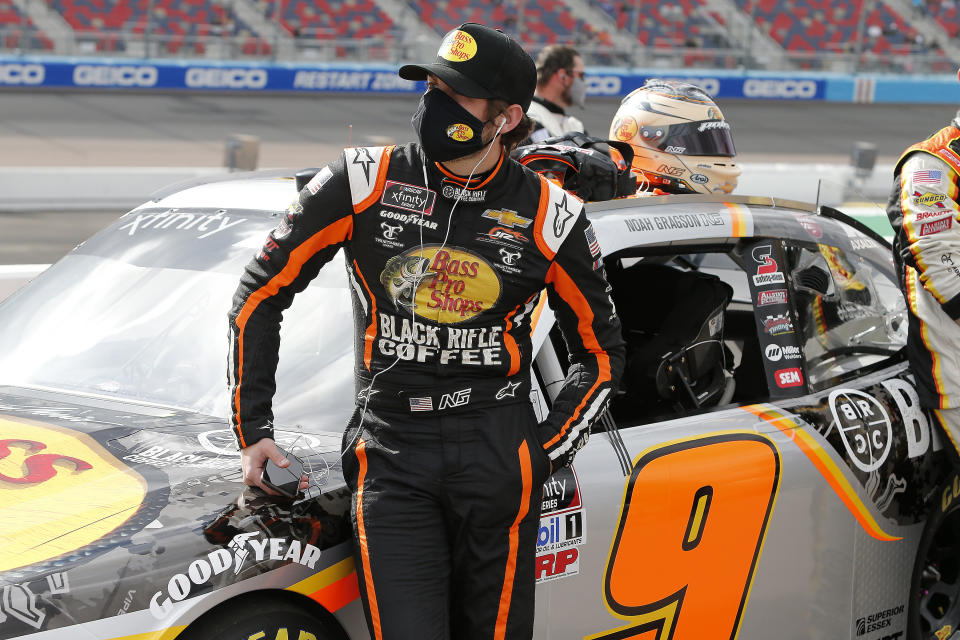 FILE - Noah Gragson stands with his race car on pit road prior to a NASCAR Xfinity Series auto race at Phoenix Raceway in Avondale, Ariz., in this Saturday, March 13, 2021, file photo. NASCAR went with a no-call on Noah Gragson after his latest dustup, an on-track altercation with Daniel Hemric that ended with a post-race scuffle between the drivers. Analyzing the decision not to penalize Gragson for backing into Hemric on pit road must be done through an impartial lens – an impossible task for those who have already decided they don’t like the 22-year-old and don’t think he deserves his job. (AP Photo/Ralph Freso, File)