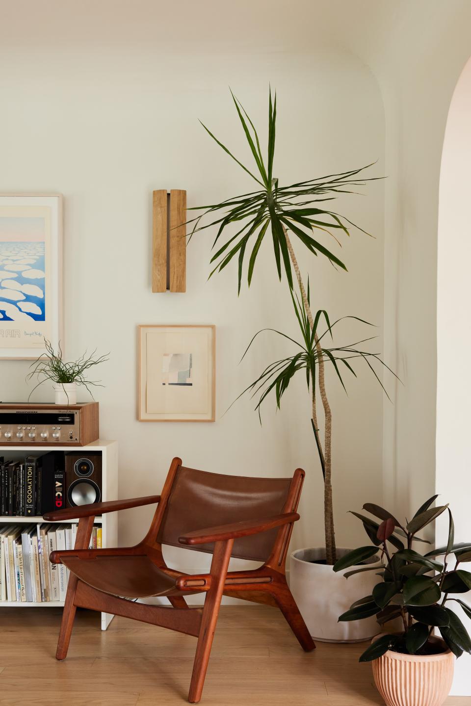 One corner of the living room is reserved for quiet contemplation. The chair is the Lars design by Room & Board. Ravenhill Studio’s ADA oak sconce, plus a small watercolor by Claire Oswalt and an artwork by Georgia O’Keeffe (partially seen above bookshelf), punctuate the wall above.