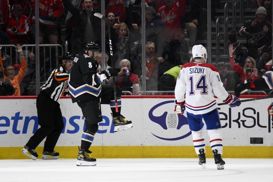 Washington Capitals left wing Alex Ovechkin (8) celebrates after his goal as Montreal Canadiens center Nick Suzuki (14) looks on during the second period of an NHL hockey game Saturday, Dec. 31, 2022, in Washington. (AP Photo/Nick Wass)