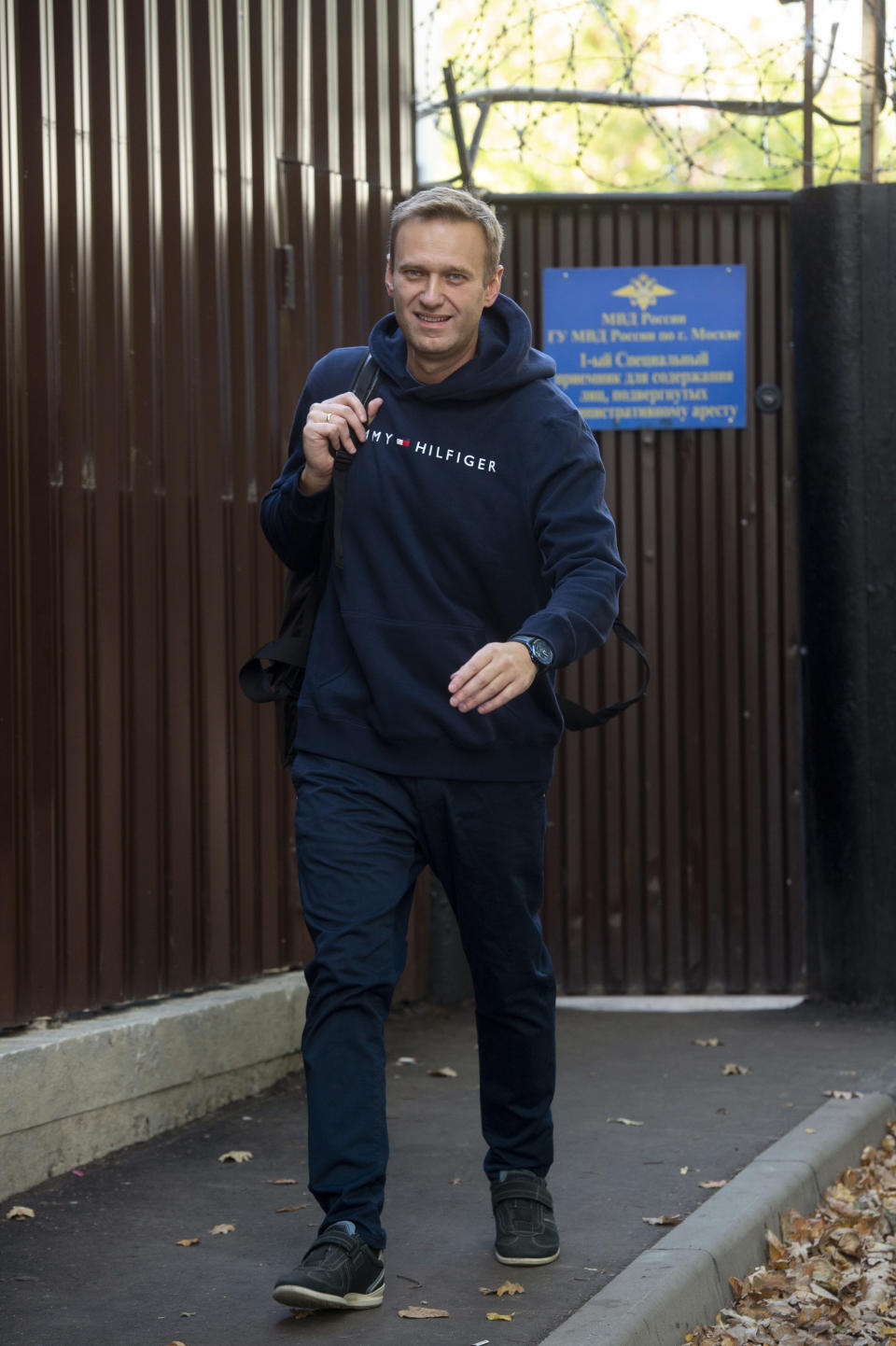 Russian opposition leader Alexei Navalny leaves a detention center after being released, in Moscow, Russia, Friday, Aug. 23, 2019. Navalny, the Kremlin's most prominent foe, was sentenced last month to 30 days for calling on people to take part in an unauthorized protest. (AP Photo/Dmitry Serebryakov)