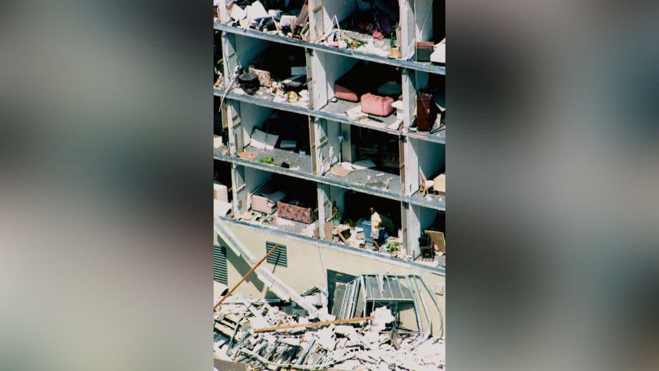 A resident looks out of his apartment after Hurricane Andrew in August 1992 blew away its walls. - Robert Sullivan/AFP/Getty Images