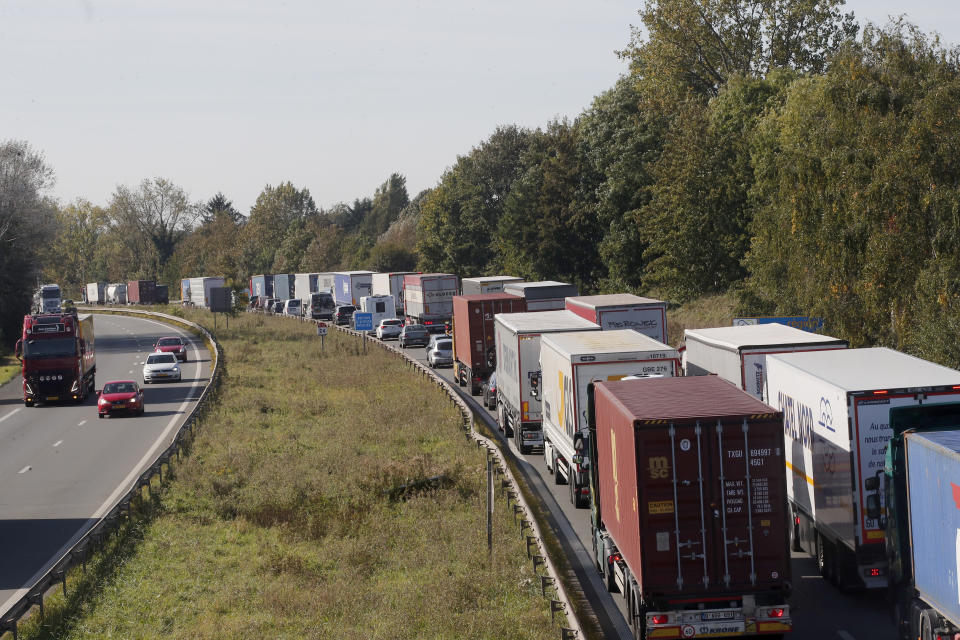 Trucks and cars line up on the highway leading to Belgium as France reinforced security at the France-Belgium border, Tuesday, Oct. 17, 2023 near Tourcoing, northern France. Police in Belgium on Tuesday shot dead a suspected Tunisian extremist accused of killing two Swedish soccer fans in a brazen shooting on a Brussels street before disappearing into the night. (AP Photo/Michel Spingler)