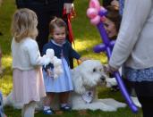 Princess Charlotte plays with a dog at a children’s tea party at Government House in Victoria, Thursday, Sept. 29, 2016. THE CANADIAN PRESS/Jonathan Hayward