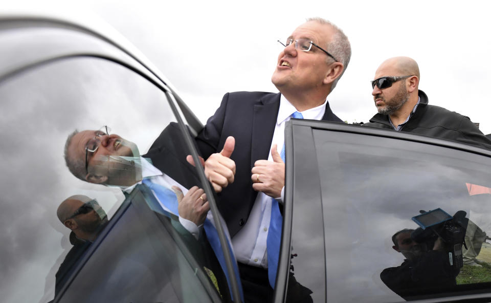 Australian Prime Minister Scott Morrison, center, visits a housing construction site in Clifton Springs, south of Melbourne, Australia, Wednesday, May 15, 2019. Both candidates, Morrison and opposition leader Bill Shorten, vying to become Australia's prime minister in elections on Saturday are promising to stay in the job for the entire three-year term, shut the revolving door to high office and put the choice of the nation's leader back in voters' hands. (Mick Tsikas/AAP Image via AP)