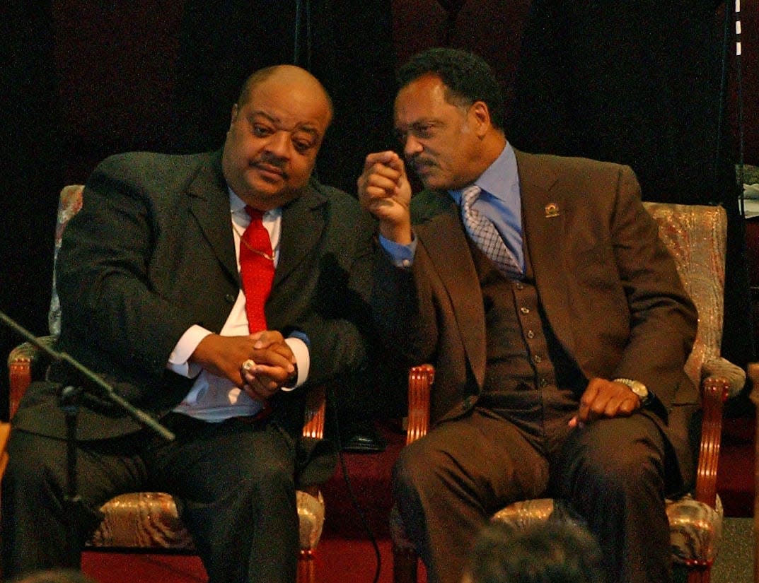 Daniels and Jesse Jackson talk quietly during mid-day services in 2004 at Holy Redeemer Church in Milwaukee.