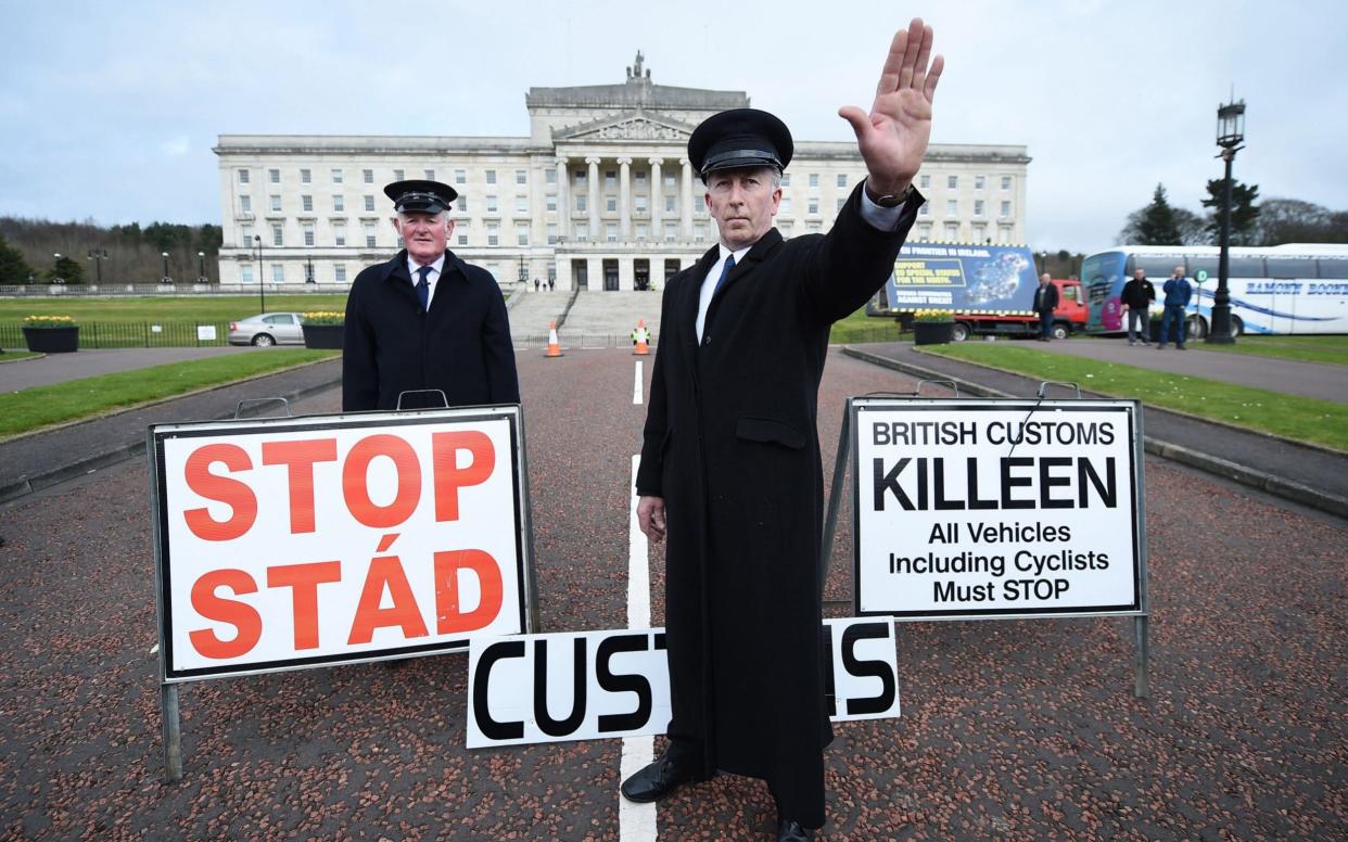 Two men dressed as customs officers take part in a protest outside Stormont against Brexit and its possible effect on the north and south Irish border - Getty Images Europe