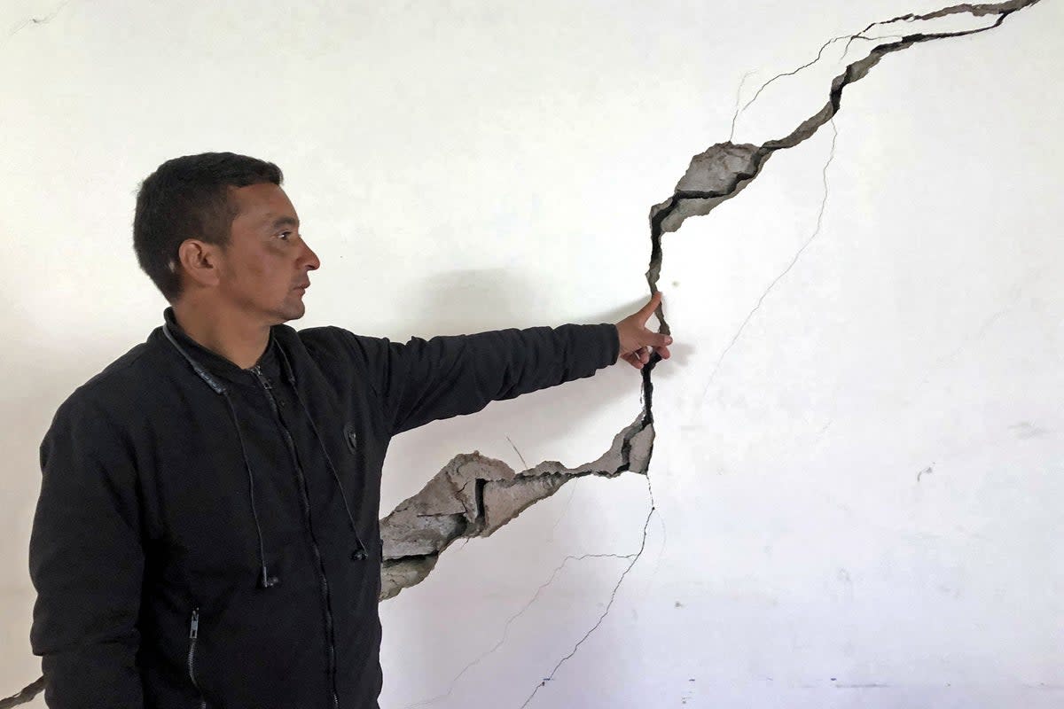 A resident shows a crack on the wall of his house at Joshimath (AFP/Getty)
