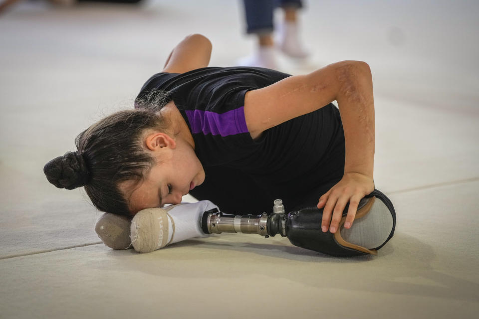 Oleksandra Paskal, an 8-year-old girl with a prosthetic leg, practices rhythmic gymnastics with other girls in Chornomorsk, Odesa region, Ukraine, Thursday, May 16, 2024. (AP Photo/Efrem Lukatsky)