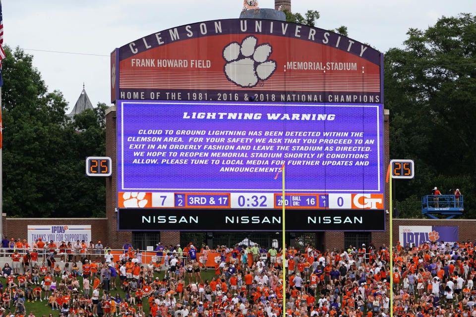 A sign warns fans about lightning in the area in the first half of an NCAA college football game between Clemson and Georgia Tech, Saturday, Sept. 18, 2021, in Clemson, S.C. The field was cleared and both teams were sent to their locker rooms. (AP Photo/John Bazemore)