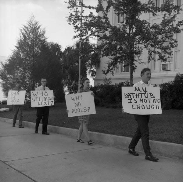Pickets again appeared before City Hall in 1966 urging the opening of the city's municipal pools. Signs carried by the pickets blamed the death of a local youth by drowning on the city's decision to keep the pools closed. The city said the pools would remain closed because of lack of funds.