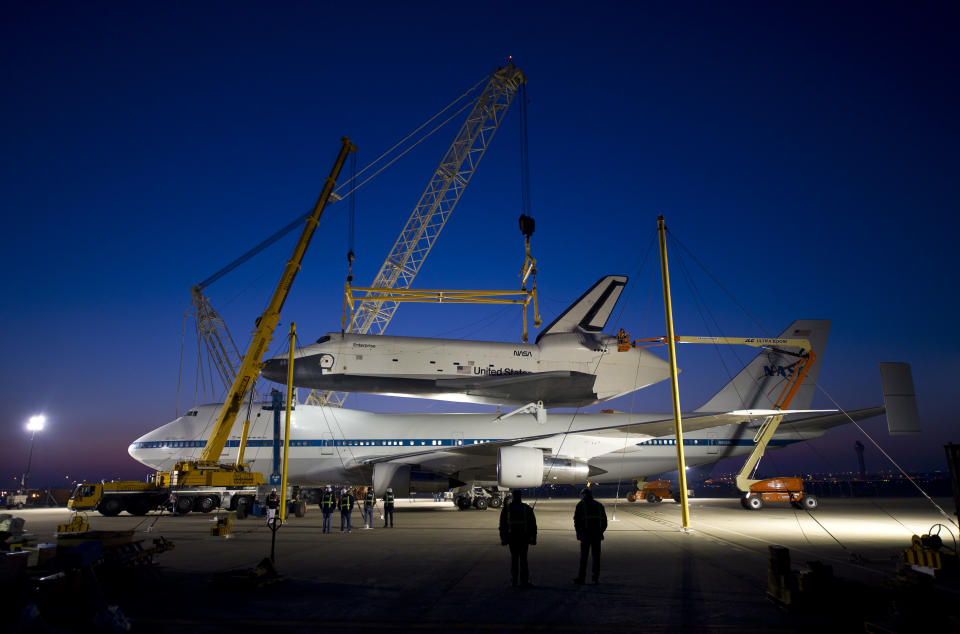 In this photo provided by NASA, the space shuttle Enterprise rests atop of the NASA 747 Shuttle Carrier Aircraft for transport to New York at Washington Dulles International Airport, Friday, April 20, 2012, in Sterling, Va. Enterprise is expected to go on display at the Intrepid Sea Air and Space Museum in New York. (AP Photo/NASA, Bill Ingalls)