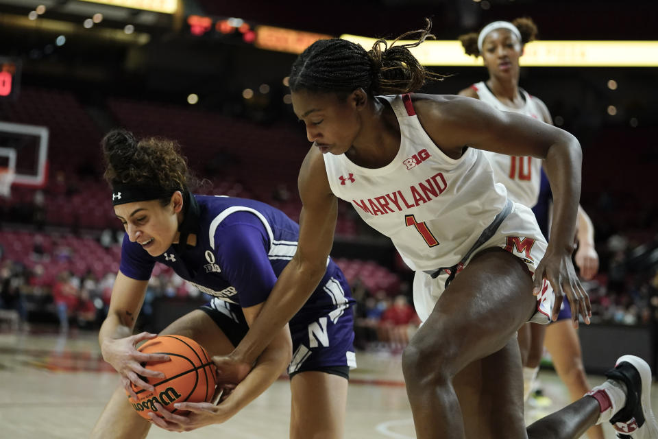 Northwestern guard Jillian Brown, left, and Maryland guard Diamond Miller compete for a loose ball during the first half of an NCAA college basketball game, Sunday, Jan. 23, 2022, in College Park, Md. (AP Photo/Julio Cortez)