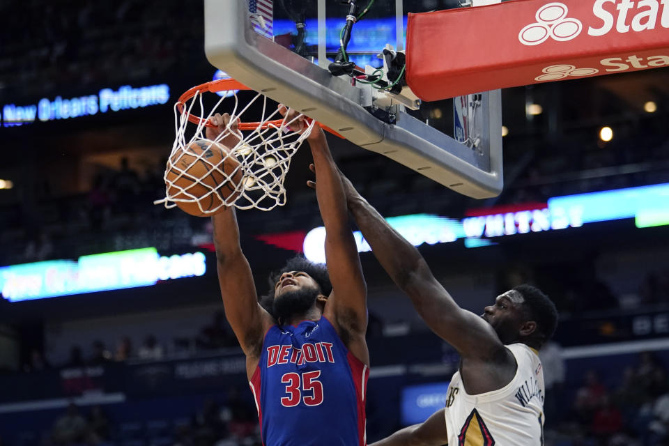 Detroit Pistons forward Marvin Bagley III (35) slam dunks as he is fouled by New Orleans Pelicans forward Zion Williamson (1) in the first half of an NBA preseason basketball game in New Orleans, Friday, Oct. 7, 2022. (AP Photo/Gerald Herbert)