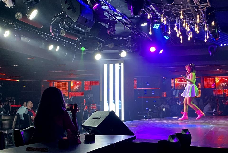 A dancer performs at a nightclub in Dubai, United Arab Emirates, Thursday, Nov. 5, 2020. As the coronavirus pandemic mutes Dubai's live-music scene, the Filipino show bands that long have animated the city's storied nightlife are being disproportionately squeezed. Many are out of work and out of money, struggling to survive in overcrowded dormitories at the mercy of employers (AP Photo/Kamran Jebreili)