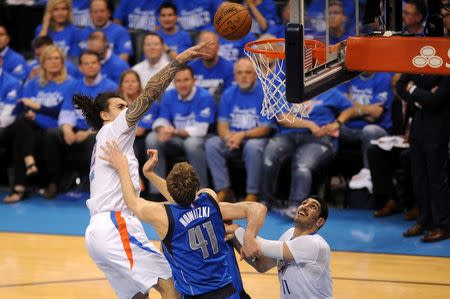 Apr 25, 2016; Oklahoma City, OK, USA; Oklahoma City Thunder center Steven Adams (12) is fouled on a shot attempt by Dallas Mavericks forward Dirk Nowitzki (41) during the second quarter in game five of the first round of the NBA Playoffs at Chesapeake Energy Arena. Mark D. Smith-USA TODAY Sports