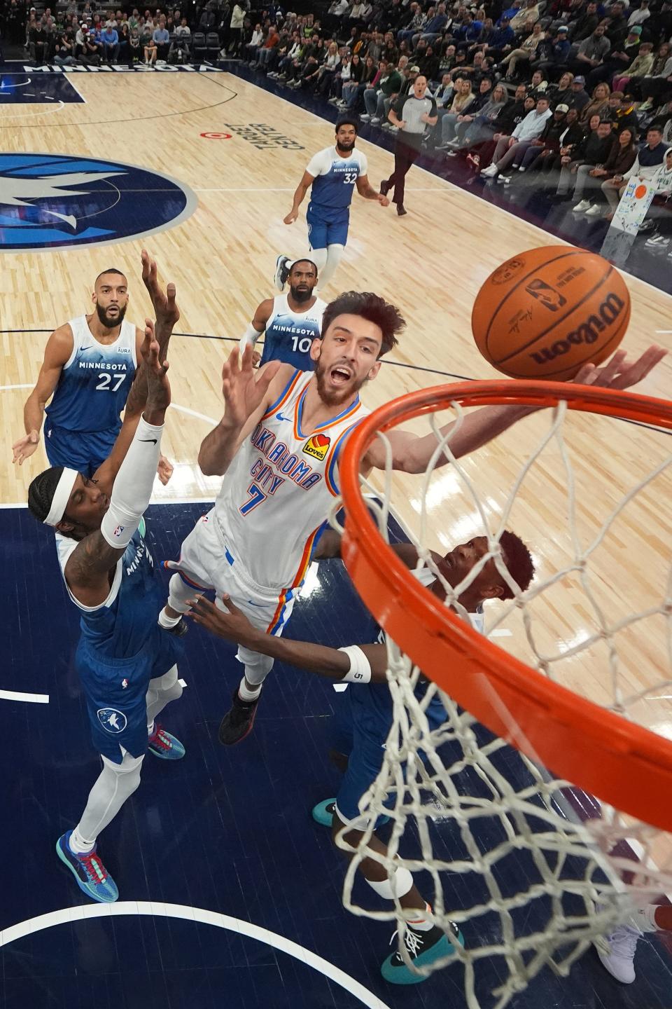 Oklahoma City Thunder forward Chet Holmgren (7) goes up for a shot as Minnesota Timberwolves forward Jaden McDaniels, left, and guard Anthony Edwards defend during the first half of an NBA basketball game, Saturday, Jan. 20, 2024, in Minneapolis. (AP Photo/Abbie Parr)