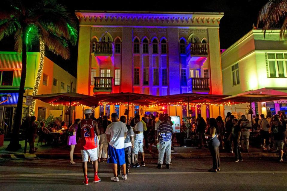 People walk Ocean Drive during the first day of Memorial Day Weekend in Miami Beach, Florida, on Friday, May 27, 2022.