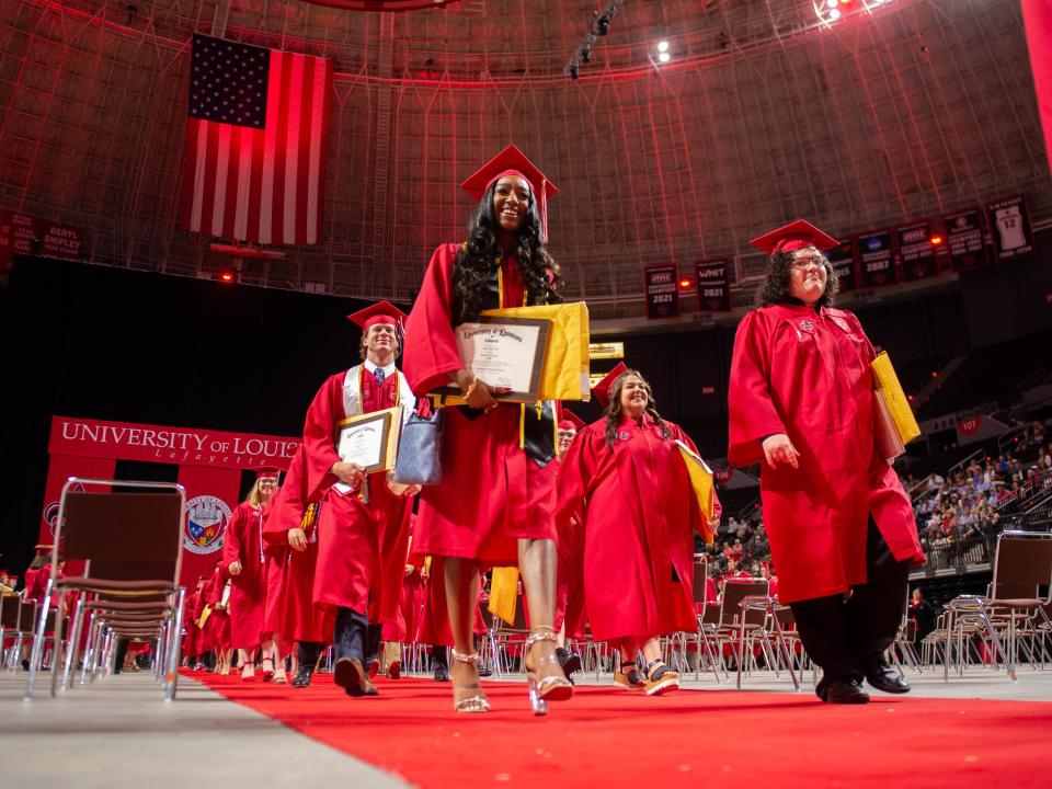 Graduates receive diplomas May 13, 2022, during the University of Louisiana at Lafayette's spring commencement.