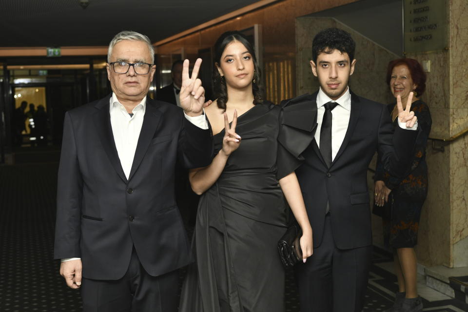 Family of Nobel Peace Prize winner Narges Mohammadi, husband Taghi Rahmani and their children Ali and Kiana Rahmani, center, arrive for the Nobel banquet at the Grand Hotel in honor of the Nobel Peace Prize laureate in Oslo, Norway, Sunday Dec. 10, 2023. Narges Mohammadi was awarded the 2023 Nobel Peace Prize in October for her decades of activism despite numerous arrests by Iranian authorities and spending years behind bars. She is renowned for campaigning for women's rights and democracy in her country, as well as fighting against the death penalty. (Rodrigo Freitas/NTB via AP)