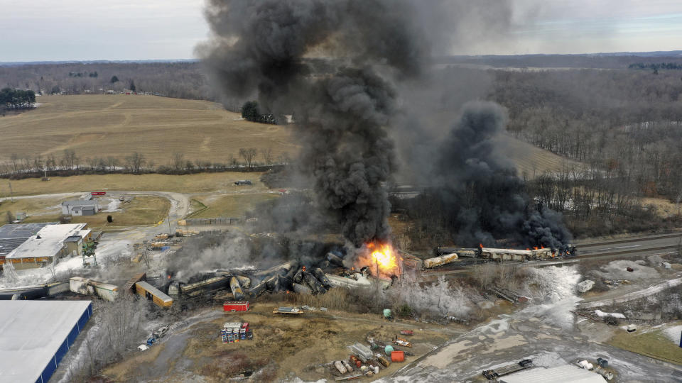 This photo taken with a drone shows portions of a Norfolk and Southern freight train that derailed Friday night in East Palestine, Ohio are still on fire at mid-day Saturday, Feb. 4, 2023. (AP Photo/Gene J. Puskar)