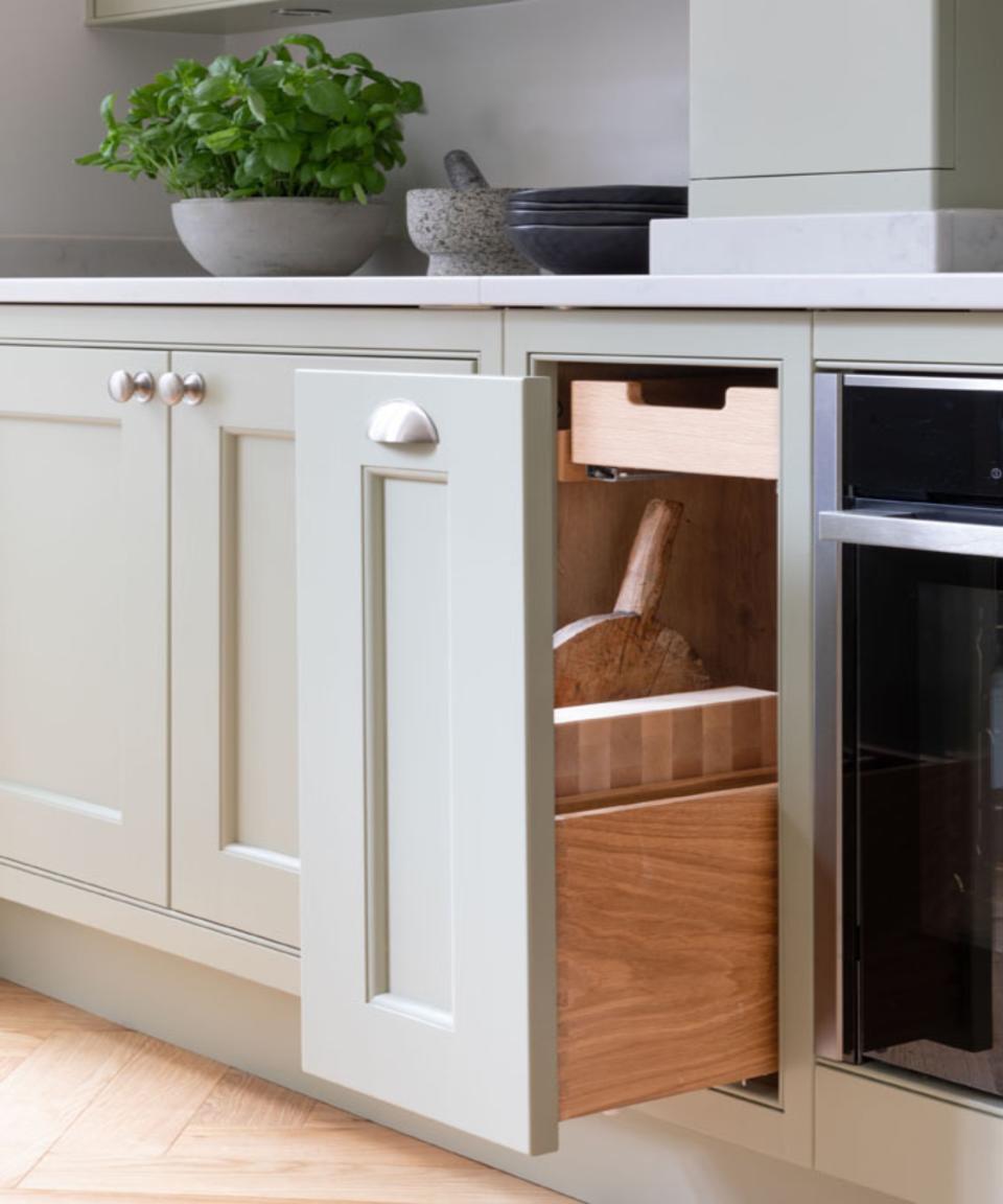 Green draws and cabinets, white countertop